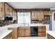 A compact kitchen featuring ample cabinet space and functional appliances with a brick accent wall at 3514 Eisenhower Dr, Indianapolis, IN 46224