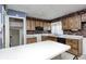 Compact kitchen with brick accent wall, offering an opportunity for a stylish remodel at 3514 Eisenhower Dr, Indianapolis, IN 46224