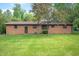 Expansive backyard features a well-maintained lawn and mature trees providing ample shade and privacy at 3605 Redfern Dr, Indianapolis, IN 46237