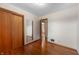 Bright bedroom with hardwood floors, closet, and an open doorway to another room at 3605 Redfern Dr, Indianapolis, IN 46237