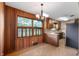 Cozy breakfast nook featuring wood-paneled walls, vintage chandelier, and bright windows at 3605 Redfern Dr, Indianapolis, IN 46237