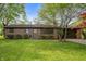 Charming brick ranch with manicured lawn, mature trees, and attached two-car garage at 3605 Redfern Dr, Indianapolis, IN 46237