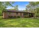 Charming brick ranch with manicured lawn, mature trees, and attached two-car garage at 3605 Redfern Dr, Indianapolis, IN 46237