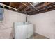 Laundry area features a white washer and dryer against light pink cinderblock walls at 3605 Redfern Dr, Indianapolis, IN 46237