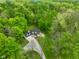 Aerial view of a charming home surrounded by lush greenery and mature trees at 3660 S Conservation Club Rd, Morgantown, IN 46160