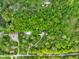 Aerial view showcasing the property's lush surroundings and mature trees at 3660 S Conservation Club Rd, Morgantown, IN 46160