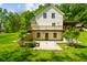 Two-story home with a walk-out basement, lush yard, and surrounding trees at 3660 S Conservation Club Rd, Morgantown, IN 46160