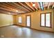 Unfinished basement with exposed beams and walkout door at 3660 S Conservation Club Rd, Morgantown, IN 46160