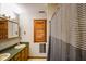 Bathroom with double sinks, wooden cabinets, and wooden window shutters at 3660 S Conservation Club Rd, Morgantown, IN 46160