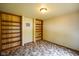 Bedroom with built-in wooden bookshelves and patterned carpet at 3660 S Conservation Club Rd, Morgantown, IN 46160