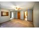 Large bedroom with carpet, neutral walls, and multiple access doors at 3660 S Conservation Club Rd, Morgantown, IN 46160
