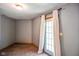 Small bedroom with a door to outside and gray-painted walls at 3660 S Conservation Club Rd, Morgantown, IN 46160