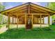 Covered porch with exposed beams and green yard at 3660 S Conservation Club Rd, Morgantown, IN 46160