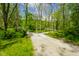 Gravel driveway with warning sign leading to home surrounded by lush greenery at 3660 S Conservation Club Rd, Morgantown, IN 46160
