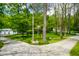Gravel driveway leading to home with lush greenery and trees at 3660 S Conservation Club Rd, Morgantown, IN 46160