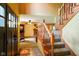 Inviting foyer with tile floor, wooden staircase, and view into the living room at 3660 S Conservation Club Rd, Morgantown, IN 46160