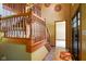 Inviting foyer with tile floor, wooden staircase, and craftsman door at 3660 S Conservation Club Rd, Morgantown, IN 46160