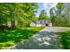 Traditional home featuring an attached garage, lush green lawn, and mature trees at 3660 S Conservation Club Rd, Morgantown, IN 46160