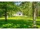 Traditional home surrounded by mature trees and lush lawn providing privacy and seclusion at 3660 S Conservation Club Rd, Morgantown, IN 46160