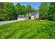 Traditional home on a large green lot featuring an attached garage and mature trees at 3660 S Conservation Club Rd, Morgantown, IN 46160
