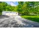 Oversized garage on large lush lot near the home with mature trees at 3660 S Conservation Club Rd, Morgantown, IN 46160