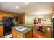 Open kitchen with stainless steel appliances, green countertop island, and view of the living room at 3660 S Conservation Club Rd, Morgantown, IN 46160