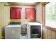Laundry room with washer, dryer, upper cabinets, and a window allowing natural light at 3660 S Conservation Club Rd, Morgantown, IN 46160