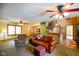 Spacious living room with a traditional staircase, comfortable seating, and a view of the dining area at 3660 S Conservation Club Rd, Morgantown, IN 46160