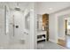 Bright bathroom with shower, tiled floors, white vanity, and brick accent wall at 3744 S Meridian St, Indianapolis, IN 46217