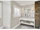 Bathroom with tiled floor, shower, white vanity and exposed brick accent wall at 3744 S Meridian St, Indianapolis, IN 46217