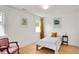 Bright bedroom features wood floors, white walls, and a cozy vintage chair at 3744 S Meridian St, Indianapolis, IN 46217