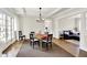 Elegant dining room with a stylish chandelier, wainscoting detail, and lots of natural light at 3744 S Meridian St, Indianapolis, IN 46217