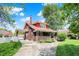 Exterior view of a red brick house with well-maintained lawn, driveway and charming landscaping at 3744 S Meridian St, Indianapolis, IN 46217