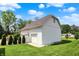 Three car garage with white siding, red roof and well maintained lawn at 3744 S Meridian St, Indianapolis, IN 46217