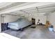 Spacious garage with a car under a cover, exercise equipment and storage shelving at 3744 S Meridian St, Indianapolis, IN 46217