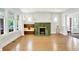 Bright living room with a tiled fireplace, hardwood floors, and an eye-catching window seat at 3744 S Meridian St, Indianapolis, IN 46217