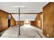 Attic featuring wood-paneled walls, and a central support beam at 3975 Denwood Dr, Indianapolis, IN 46226
