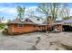 View of the yard with brick home in the background, featuring a patio and various vehicles at 3975 Denwood Dr, Indianapolis, IN 46226