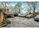 View of the yard with assorted vehicles and a brick home in the background at 3975 Denwood Dr, Indianapolis, IN 46226