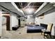 A partially finished basement with concrete floors and exposed ceiling features a bed frame and assorted furniture at 3975 Denwood Dr, Indianapolis, IN 46226