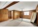 A largely unfinished basement featuring wood paneling, drop ceiling and support beams at 3975 Denwood Dr, Indianapolis, IN 46226