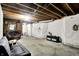Spacious basement with concrete floors, exposed ceilings, and casual seating at 3975 Denwood Dr, Indianapolis, IN 46226