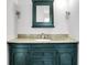 Bathroom vanity with granite countertop, green cabinets, and modern lighting at 3975 Denwood Dr, Indianapolis, IN 46226