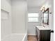 Bathroom featuring vanity, mirror, lighting, shower/tub with white subway tile surround at 3975 Denwood Dr, Indianapolis, IN 46226