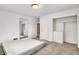 Bright bedroom featuring neutral walls, carpet, built-in closet, and a large mirror at 3975 Denwood Dr, Indianapolis, IN 46226