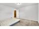 A bright bedroom with carpeted floors and a doorway to closet or bathroom at 3975 Denwood Dr, Indianapolis, IN 46226