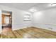 Clean, bright room with wood-look floors, a window, and neutral walls, offering a versatile space at 3975 Denwood Dr, Indianapolis, IN 46226
