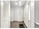 Bright hallway with white walls, multiple closet doors, neutral carpeting, and a simple yet elegant light fixture at 3975 Denwood Dr, Indianapolis, IN 46226