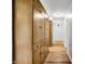 Hallway featuring built-in wooden cabinets and laminate flooring at 3975 Denwood Dr, Indianapolis, IN 46226