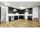 A bright and airy kitchen featuring black cabinets and laminate flooring at 3975 Denwood Dr, Indianapolis, IN 46226